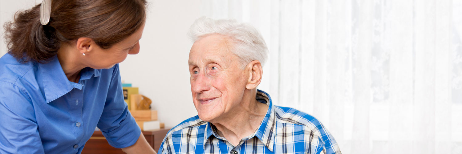 caregiver and elderly man talking